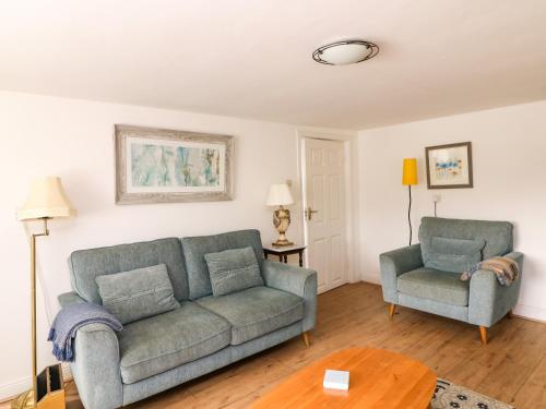 a living room with a couch and two chairs at The Dairy in New Ross