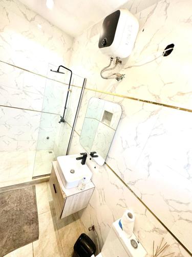 a bathroom with a sink and a shower at Two Bedroom Home in Lekki in Lekki
