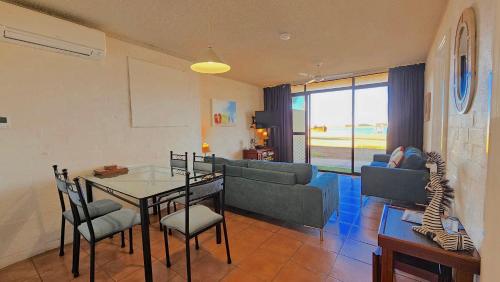 a living room with a couch and a table at Riverview Holiday Apartment 3 - Kalbarri WA in Kalbarri