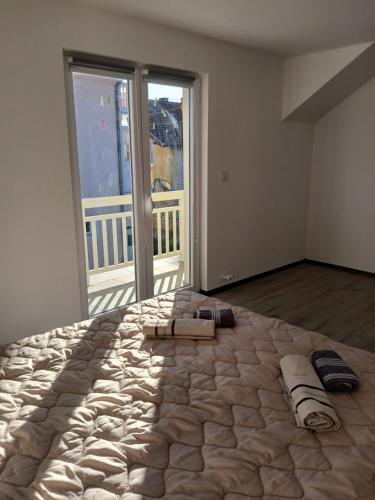 a large bed in a room with towels on it at Apartman Eni in Sarajevo