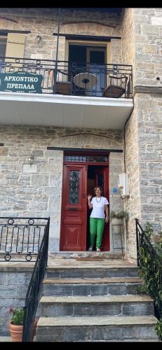 a man standing in the door of a building at Αρχοντικό Πρεπάλα in Neochori