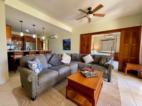 a living room with a couch and a table at The Villas at Cocoplum in Placencia Village