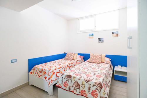 a small bedroom with a bed and a window at Villa con piscina in parco privato in Agnone