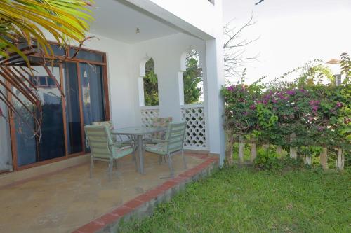 a patio with a table and chairs on a house at Victorious Kings Homes in Mtwapa
