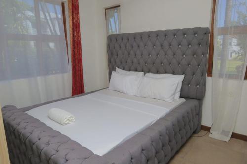 a large bed in a small room with a large bed sidx sidx sidx at Victorious Kings Homes in Mtwapa