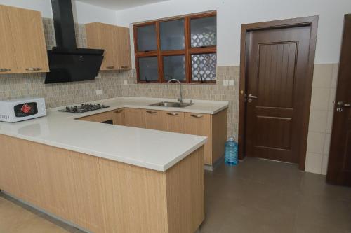a kitchen with a sink and a counter top at Victorious Kings Homes in Mtwapa