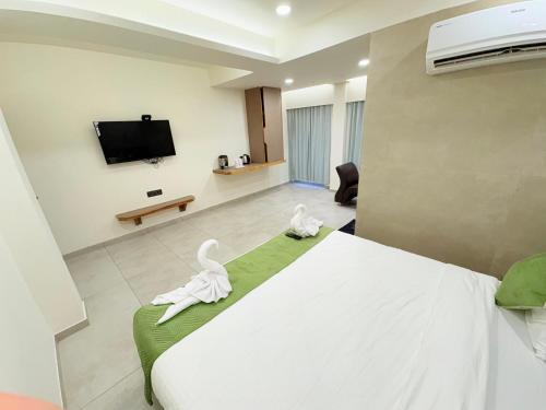 a hotel room with a bed and a tv at Hotel city inn in Ahmedabad
