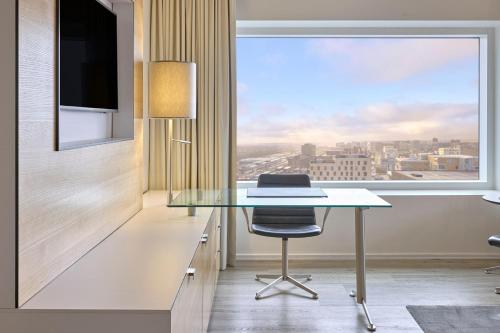 an office with a glass desk and a window at Crowne Plaza Copenhagen Towers by IHG in Copenhagen