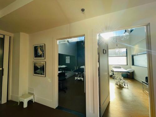 a room with a hallway with a room with a table at Solara Getaway 2BR Condo with Pool - Hot Tub - Gym - Spa in Canmore