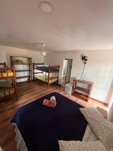 a room with a bed and a room with two bunk beds at Fauna in Praia do Bananal