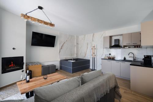 a living room with a couch and a kitchen at Πηγή Τραγανιστή in Kato Trikala Korinthias