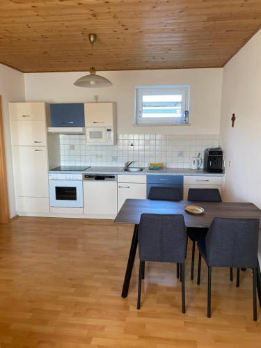 a kitchen with a table and chairs in a room at Ferienwohnung Maier in Fürstenfeld