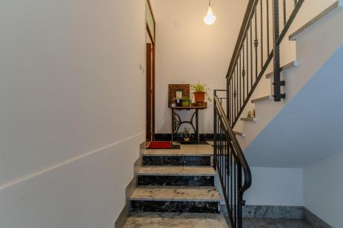 a staircase in a home with a stair case at CasaBlanc in Santa Teresa di Riva