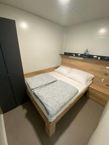 a small bedroom with a bed in a room at Green Hill Mobile Home in Ražanac