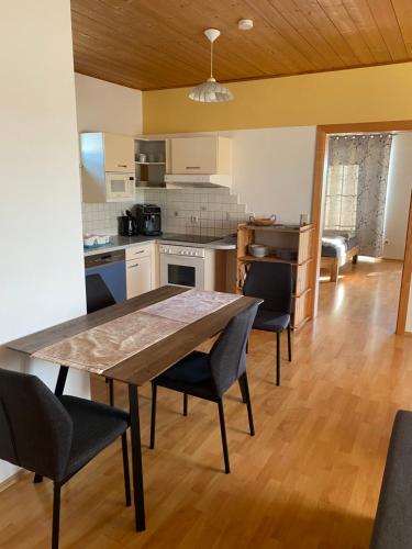 a kitchen and dining room with a table and chairs at Ferienwohnung Maier in Fürstenfeld