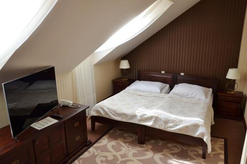 Ένα ή περισσότερα κρεβάτια σε δωμάτιο στο Hotel Nowodworski