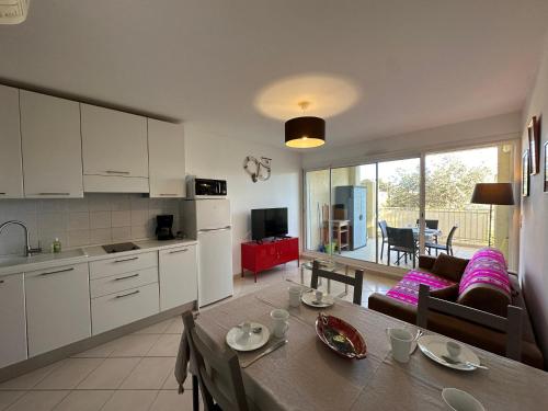 Il comprend une cuisine et un salon avec une table. dans l'établissement Appartement 2 pièces, 4 couchages L'Ile-Rousse, à LʼÎle-Rousse