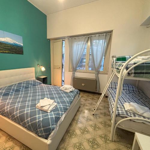 a bedroom with two bunk beds and a window at Althea Etna Garden in Nicolosi