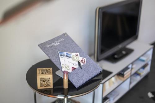 a table with a graduation cap and a book on it at Chasa Arpiglia in Guarda