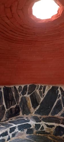 a room with a ceiling with a rock at Mindfulness Glamping, Retiro de Yoga, Todo Incluido in Mexico City