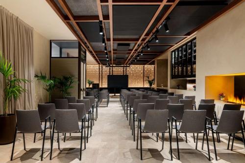 a conference room with chairs and a screen at Radisson Collection Hotel, Magdalena Plaza Sevilla in Seville