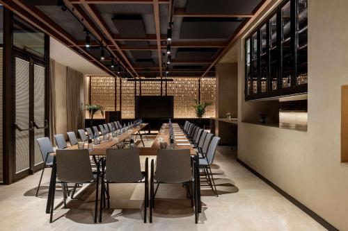 a large conference room with a long table and chairs at Radisson Collection Hotel, Magdalena Plaza Sevilla in Seville