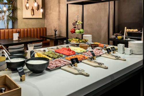 a buffet with meats and vegetables on a table at Radisson Collection Hotel, Magdalena Plaza Sevilla in Seville