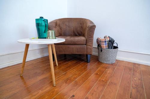 a chair and a table with a chair and a table at Lisbonera Guest House in Lisbon