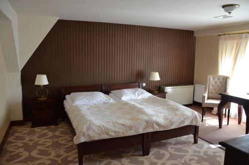 Ένα ή περισσότερα κρεβάτια σε δωμάτιο στο Hotel Nowodworski