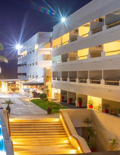 a building with a staircase in front of it at night at Emporio Mazatlan in Mazatlán