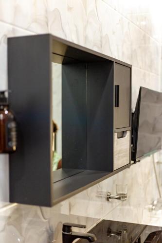 a mirror above a sink in a bathroom at B&M residence in Dawhwenya