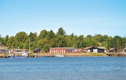 a large body of water with houses and a dock at Nice Home In Højslev With Kitchen in Højslev