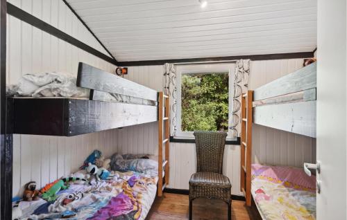 a bedroom with two bunk beds and a chair at Nice Home In Højslev With Kitchen in Højslev