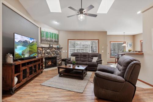 a living room with couches and a tv and a fireplace at 8732 Clarkview in Hayden