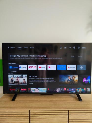 a flat screen tv sitting on top of a table at Infinity view residence in Sannat