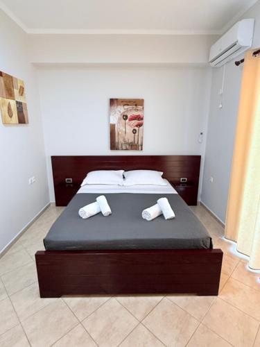 a bedroom with a bed with two towels on it at Hotel Milo Ksamil in Ksamil