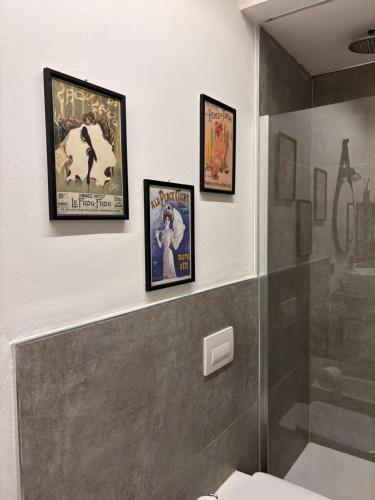 a bathroom with three framed movie posters on the wall at Gemmas home in Uboldo