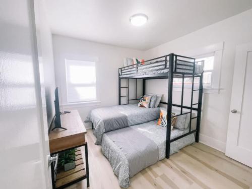 a bedroom with two bunk beds and a television at Modern Gem in North Park in San Diego