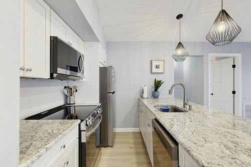 a white kitchen with a sink and a counter top at Sea Colony - 4203 Rally in Bethany Beach