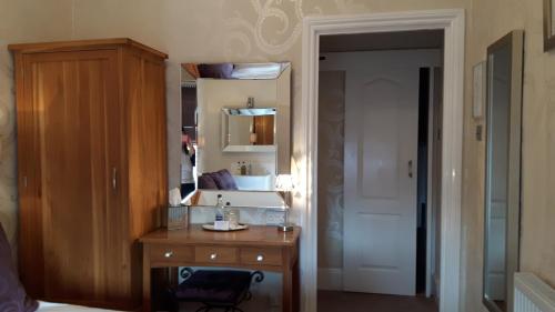 a bathroom with a sink and a mirror at The Ambassador Townhouse in Southport