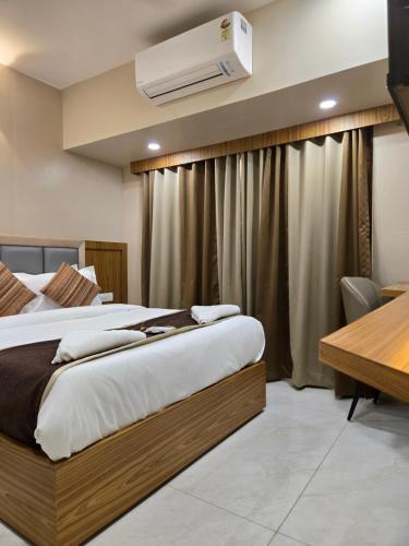 a hotel room with two beds and a air conditioner at Galaxy Stays BKC in Mumbai