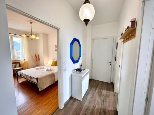 a bedroom with a bed and a mirror on the wall at Casa Viola - Near the beach in Domaso