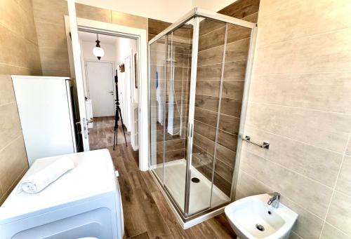 a bathroom with a shower and a sink and a toilet at Casa Viola - Near the beach in Domaso