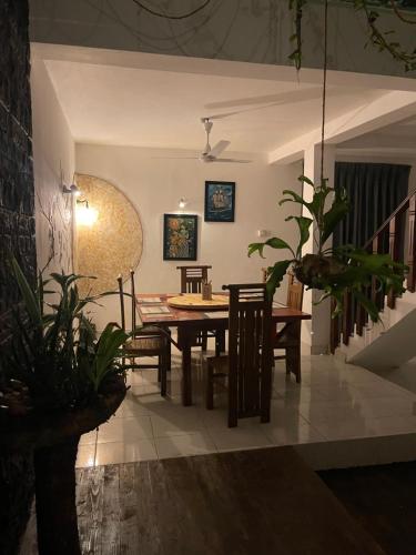 a dining room with a table and chairs at The Art House in Minuwangoda