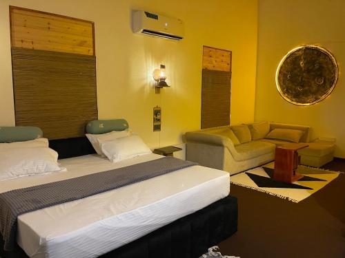 a hotel room with a bed and a couch at The Art House in Minuwangoda
