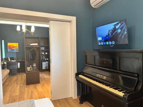 a room with a piano and a living room at Sunset Guest House in Reggio Calabria