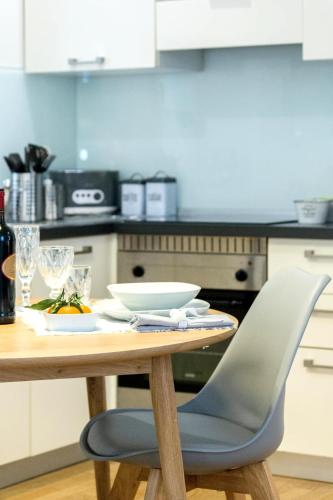 a wooden table with a chair in a kitchen at COSY and CHIC to the LAKE in Como