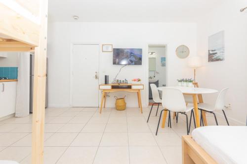 a white living room with a table and chairs at Ocean Villa in Miami Beach