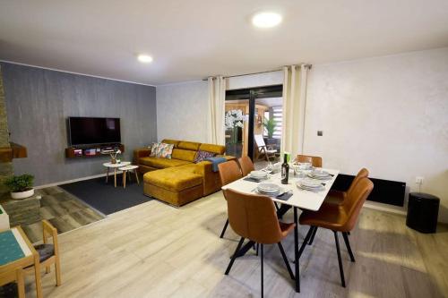 a living room with a table and a couch at Holiday House Papuk in Novo Zvecevo