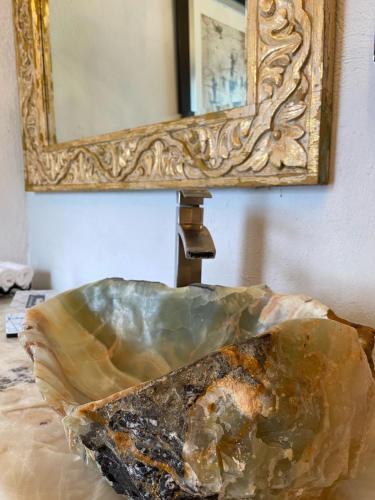 a mirror sitting on a table next to a rock at Hacienda del Lago Boutique Hotel in Ajijic